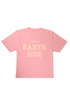 Pink t-shirt with 'EARTH SIDE' text on a white background